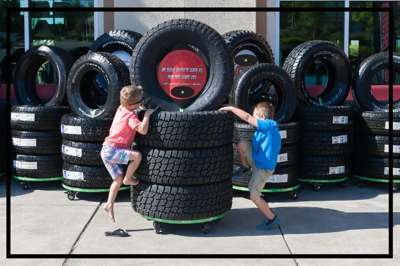 Children climbing on a TruStack tire display outside a tire store